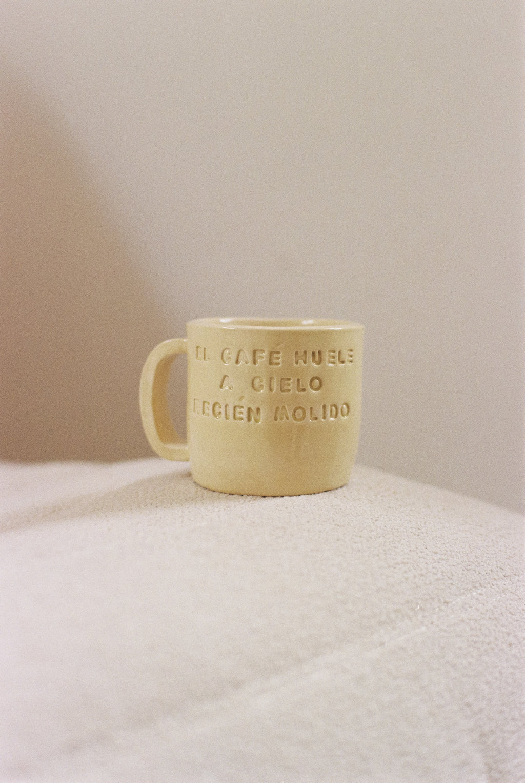 Yellow ceramic mug with phrase