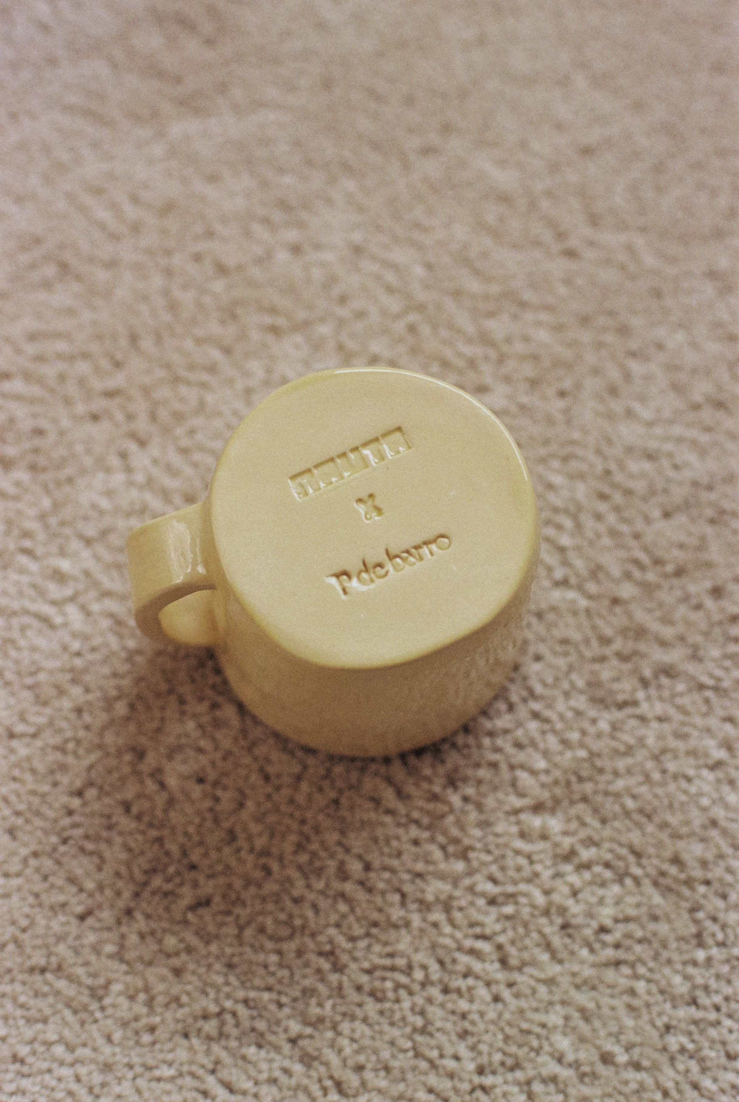Yellow ceramic mug with phrase