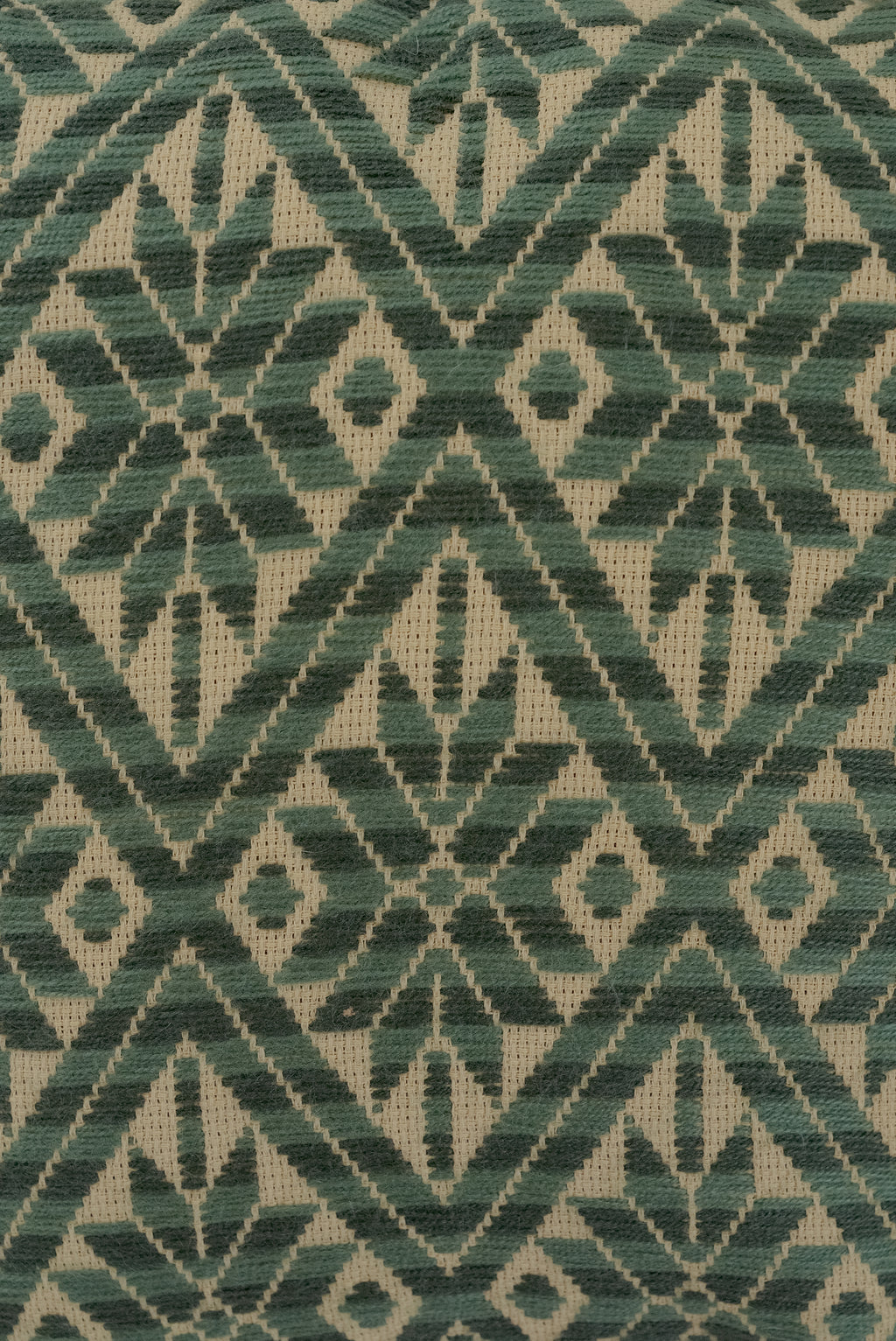 Cushion with embroidered green cover